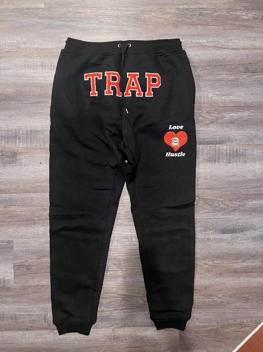 TRAP BLACK AND ORANGE SWEATPANTS